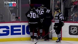 Jimmy Vesey helped off the ice after contact with Braden Schneider