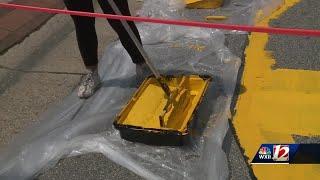 Greensboro artist begins painting street 'One Love' mural