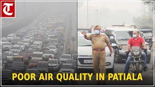 Traffic policemen and commuters cover their faces in Patiala as air quality is poor