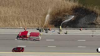 Firefighters attack a brushfire along Interstate 690 near Syracuse