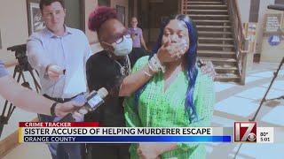 Sister accused of helping murderer escape appears in court