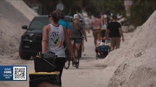 Emotions boil over with FEMA as residents in Treasure Island walk miles in heat to carry in supplies