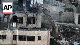 Israeli soldiers pushed three apparently lifeless bodies from roofs during West Bank raid