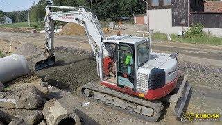 Takeuchi TB1140 excavator with PowerTilt spreading gravel