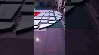 The giant circular LED interactive video floor is being assembled and tested in the factory