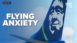 Alaska Airlines passenger climbs onto wing after plane lands at Sea-Tac