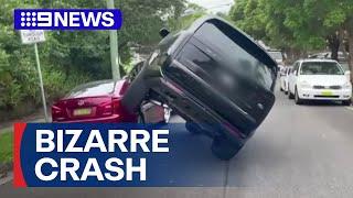 Range Rover suspended mid-air following bizarre crash | 9 News Australia