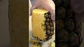 Fruit truck man's neat cutting of pineapple