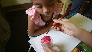 Teaching my 3 year old child to paint using a plastic roll bag. A fun activity for toddlers.