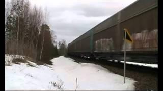 Finnish Dv12 diesel locomotive pulled heavy freight train passes dangerous crossing