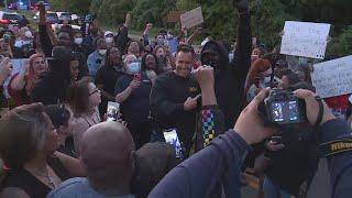 Genesee County Sheriff Chris Swanson joins protesters as they walk for George Floyd.