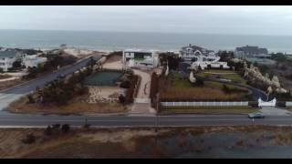 Aerial approach across bay to oceanfront houses, Hamptons