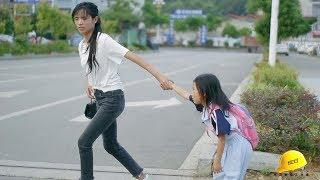 Mother took her daughter across the road, her daughter did not want to follow