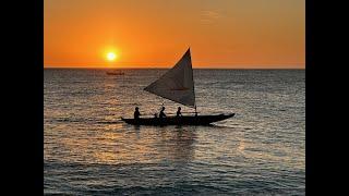 Outrigger Canoe Surfing and Sailing on Namotu Island, Fiji.