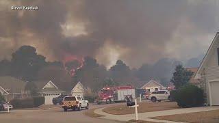 Fire crews battle massive wildfire outbreak in the Carolinas