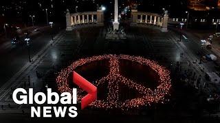 Hundreds form peace sign at candlelight vigil in Budapest in solidarity with Ukraine