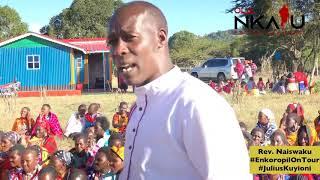 Ole Naiswaku preaching at Morijo Loita