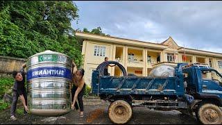 Female driver of a ben truck Bring the water tank to the village for the farmers.