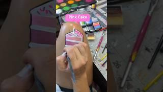 Here is a pink glitter cake painting. #facepaint #facepaintmakeup #facepainting #pinkcake