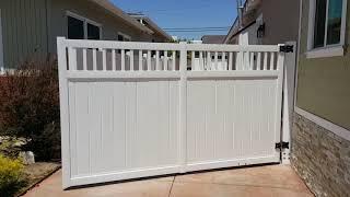 Motorised single swing gate, white vinyl privacy with picket on top.