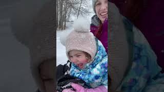 Toddler Daughter Screams in Excitement While Sledding Downhill Over Snow With Mom - 1277745