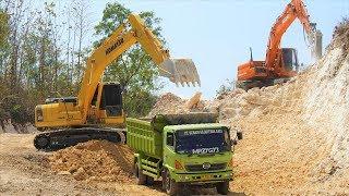 Excavator Dump Truck Digging Limestone On Road Construction Kobelco SK200 Komatsu PC200