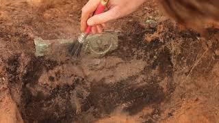 An archaelogist working on a Roman chest found in Bagington, Warwickshire