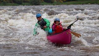 River Spey with canoe, child and dog