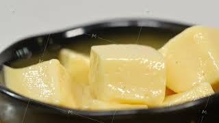 Dice butter. Making short-cut puff pastry series. Butter cubes in plate. Spread out butter on plate