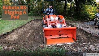 Kubota BX- Digging a pad for a shed with the FEL