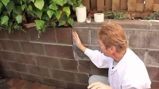 Repair a structural crack in a retaining block wall